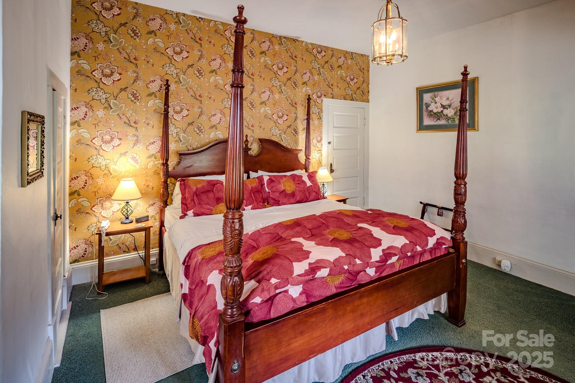 4584 Highway 194 Sugar Grove, NC 28679 - Photo 18 of 48 a bedroom with a bed and a chandelier