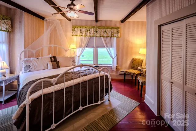 a bedroom with a bed and a painting on the wall