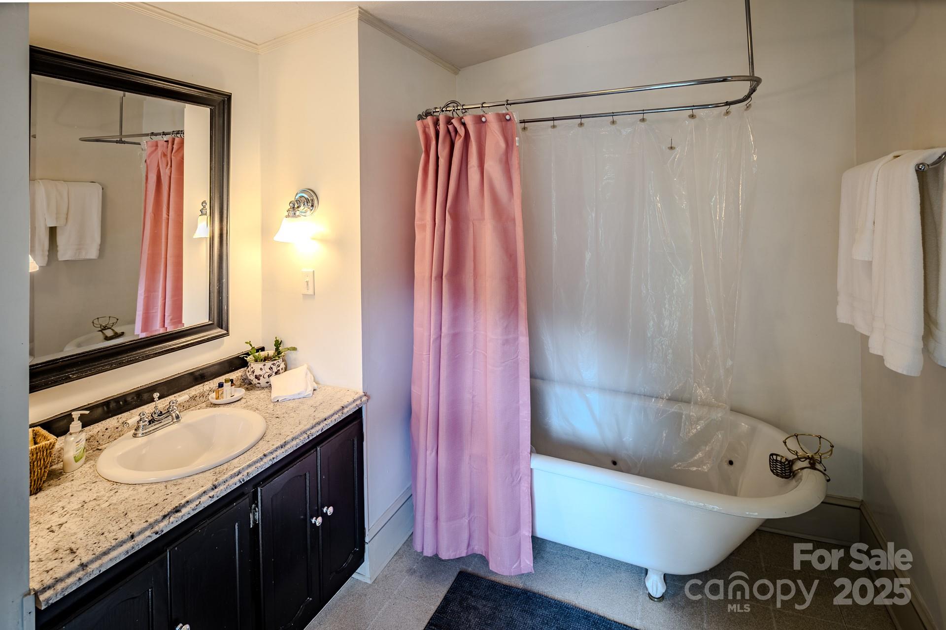4584 Highway 194 Sugar Grove, NC 28679 - Photo 25 of 48 a bathroom with a granite countertop sink a toilet and bathtub
