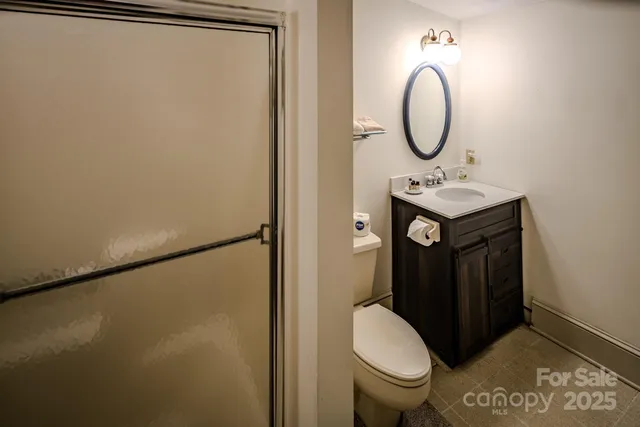 a bathroom with a sink toilet and mirror