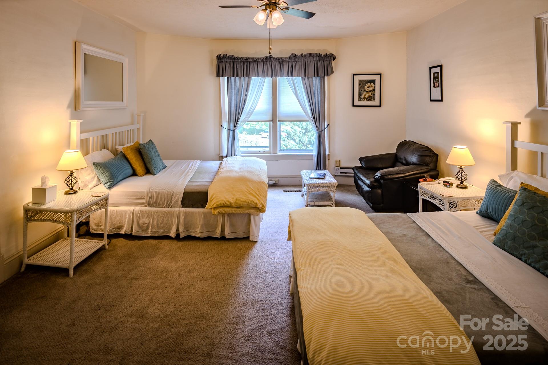 4584 Highway 194 Sugar Grove, NC 28679 - Photo 30 of 48 a spacious bedroom with a bed and a chandelier