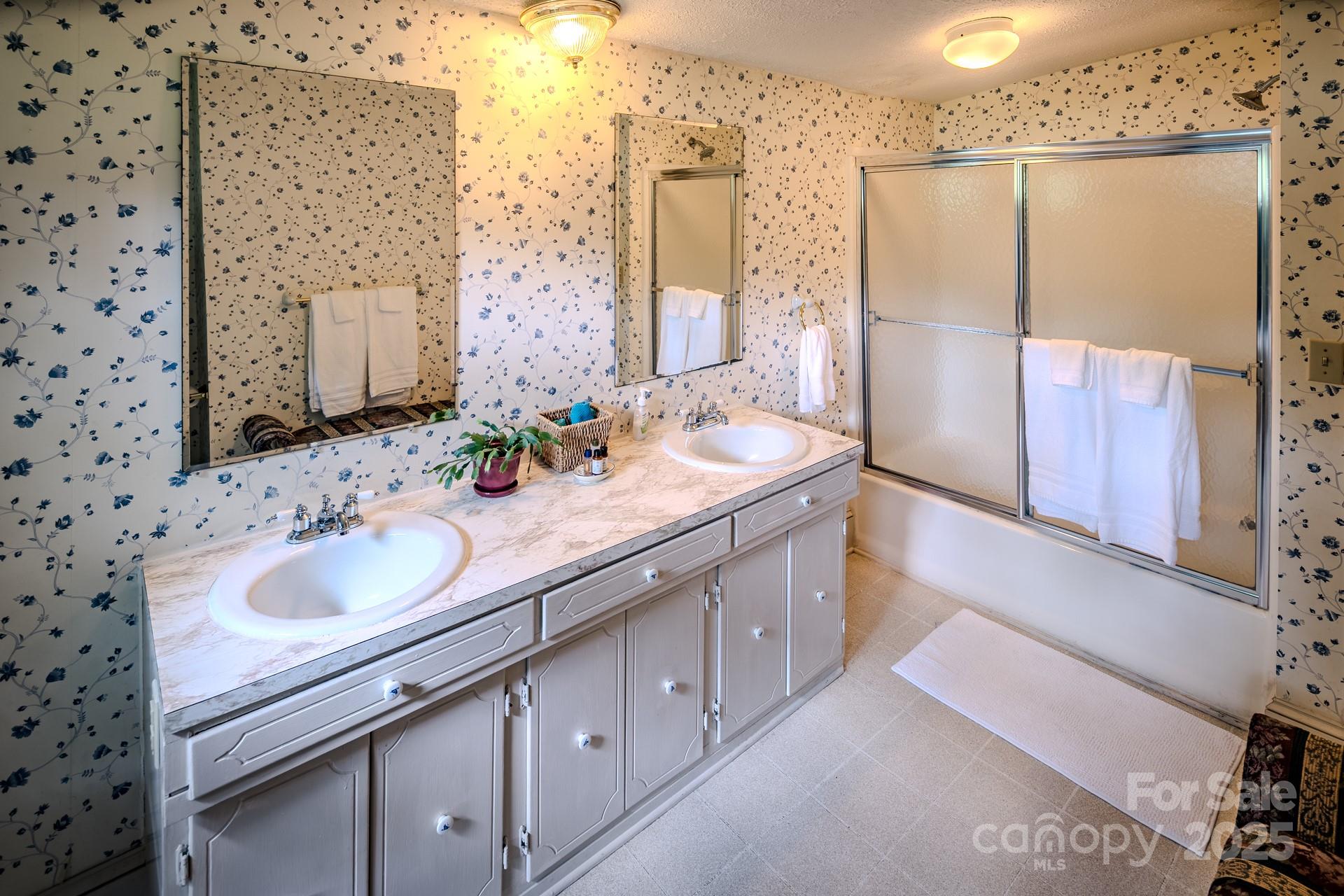 4584 Highway 194 Sugar Grove, NC 28679 - Photo 31 of 48 a bathroom with a double vanity sink and a mirror