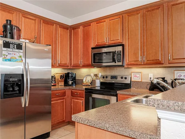 a kitchen with stainless steel appliances granite countertop a stove top oven a sink and dishwasher