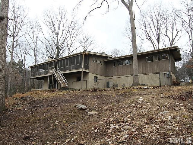 4901 Rembert Drive Raleigh, NC 27612 - Photo 25 of 25 A back view of the home. The home sits on 1.48 acres, the back yard has been left natural and the front has been professionally landscaped. Back View