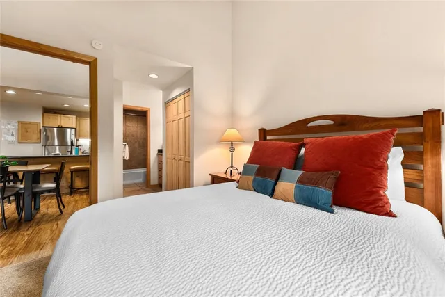 a bedroom with a bed and table chair