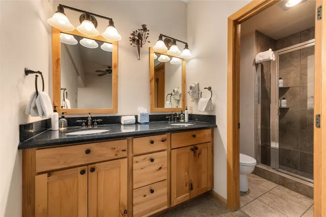a bathroom with a granite countertop sink vanity and a mirror