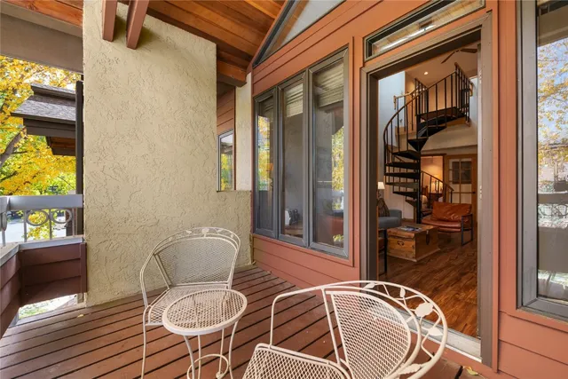 a balcony with table and chairs