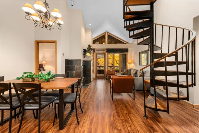 a dining room with furniture a chandelier and wooden floor
