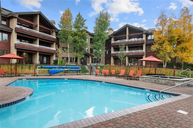 a front view of building with yard and swimming pool
