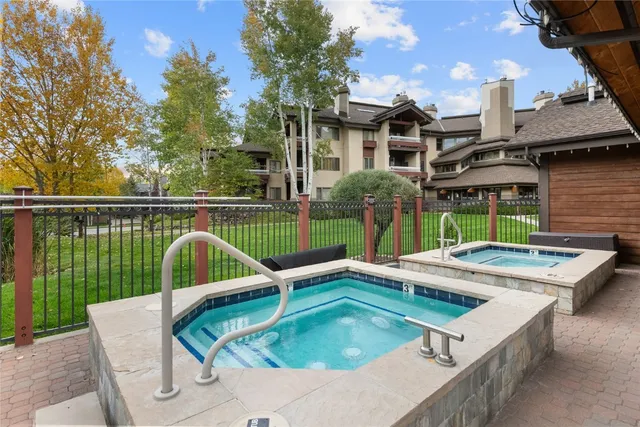 a view of a house with swimming pool and sitting area