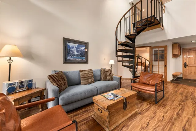 a living room with furniture a couch and a chandelier