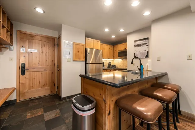 a kitchen with a refrigerator and a sink