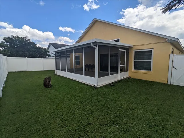 a view of a house with a backyard