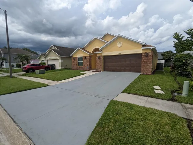 a front view of house with yard and green space