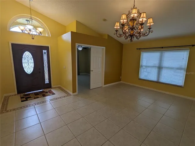 a view of a room with a chandelier and living room view