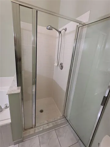 a bathroom with a glass door shower