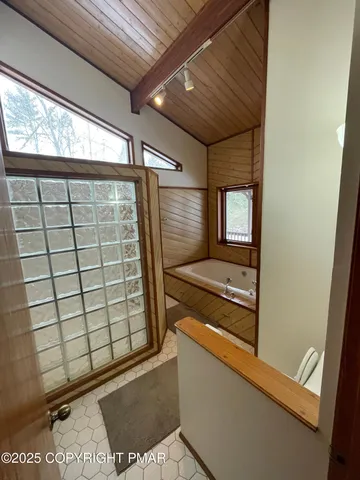 a bathroom with sink shower and mirror
