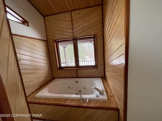 a bathroom with a tub and shower