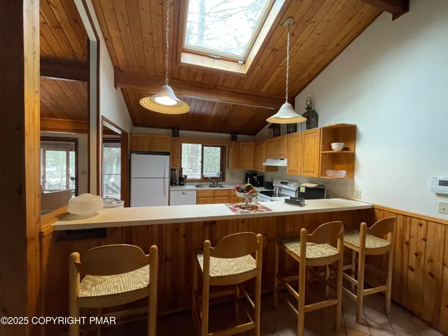 a dining table with chairs and window