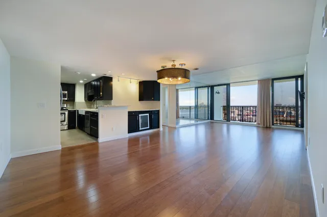 a view of a livingroom with furniture wooden floor and fire place