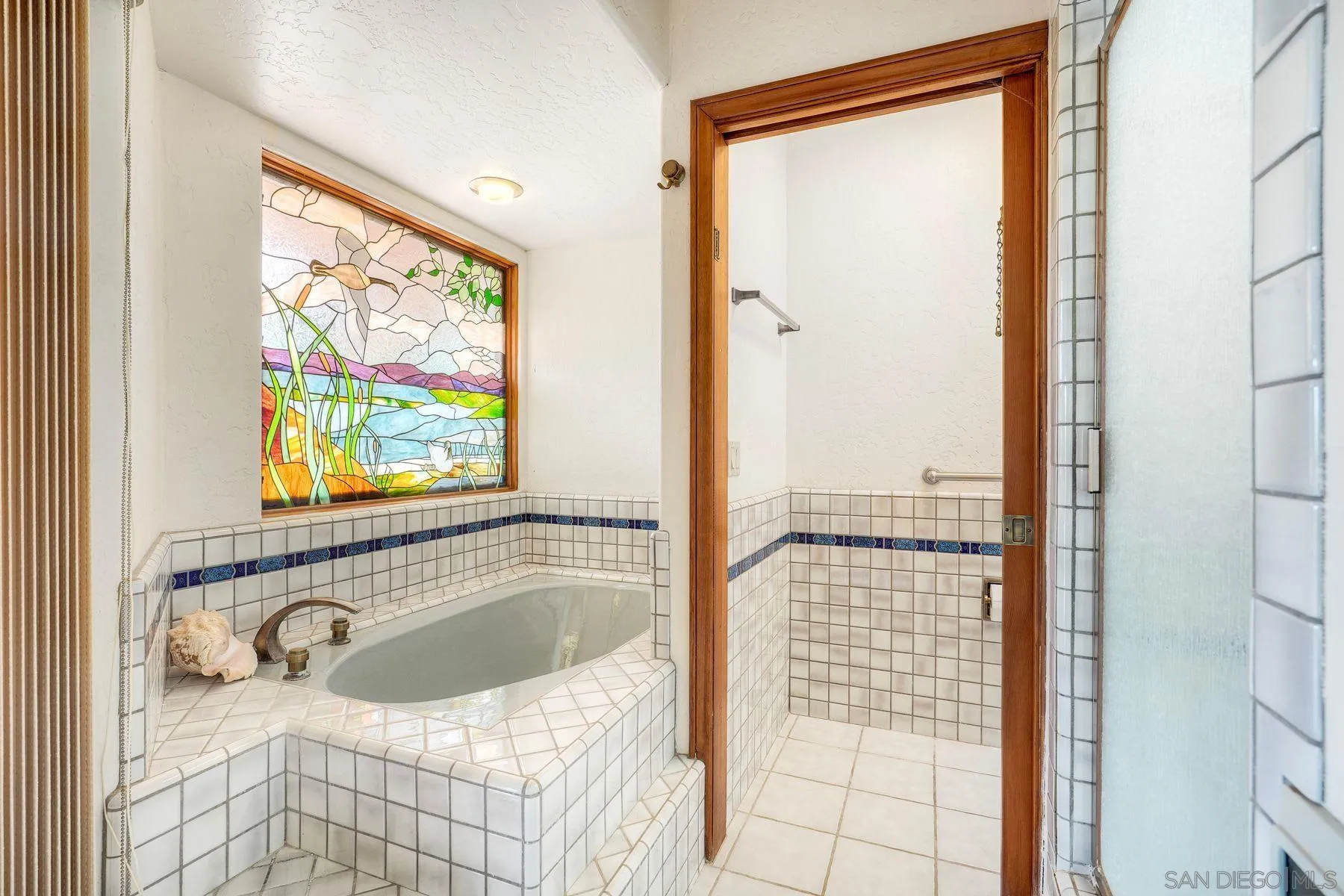 30458 Cool Valley Highlands Road Valley Center, CA 92082 - Photo 37 of 47 a bathroom with a bathtub next to a window