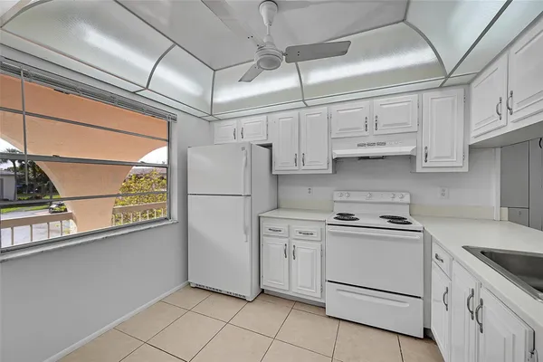 a kitchen with stainless steel appliances granite countertop a refrigerator and a stove