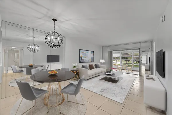 a living room with fireplace kitchen view and a large window