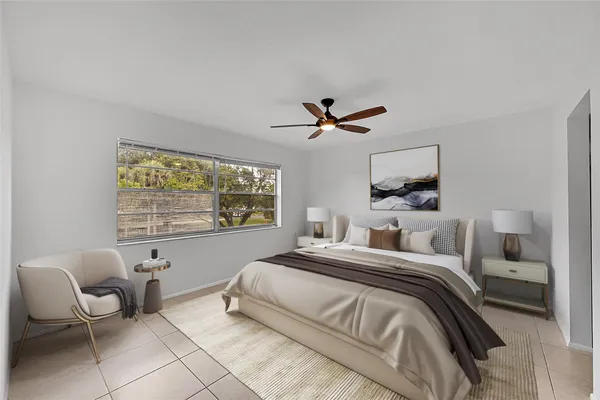 a bedroom with a bed and a large window