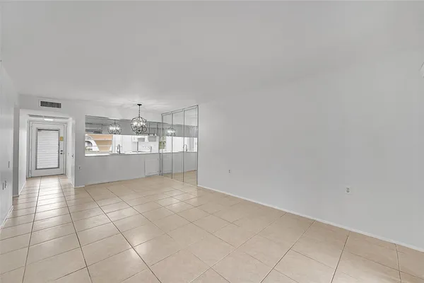 a view of a kitchen with refrigerator and cabinets