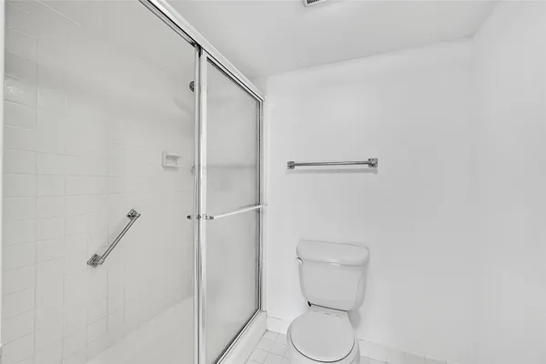 a bathroom with a toilet and a shower