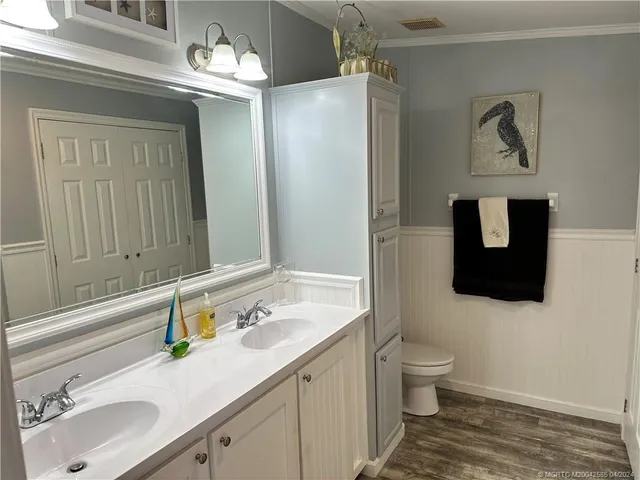 a bed room with a bed and a chandelier