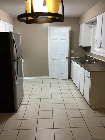 a kitchen with a black white checkered floor