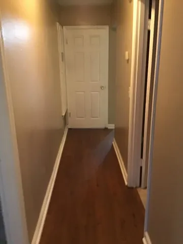 an entryway door with a hallway in a house