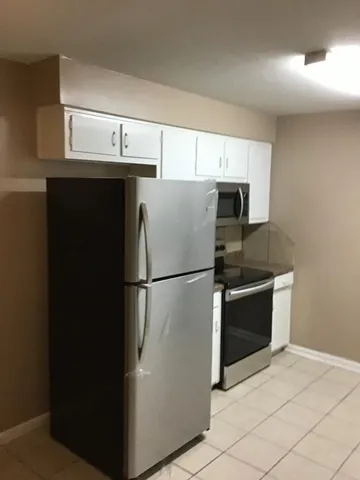 a white refrigerator freezer sitting in a kitchen