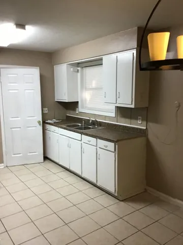 a kitchen with stainless steel appliances granite countertop a sink and a stove