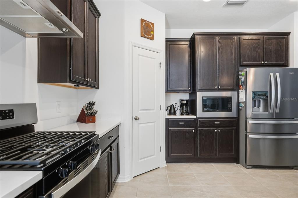 5365 Cappleman Loop Brooksville, FL 34601 - Photo 13 of 52 a kitchen with stainless steel appliances granite countertop a refrigerator and a stove top oven