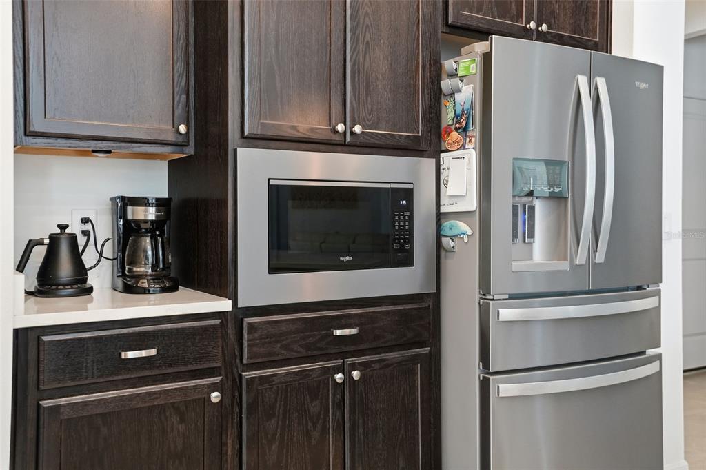 5365 Cappleman Loop Brooksville, FL 34601 - Photo 17 of 52 a kitchen with a refrigerator and cabinets