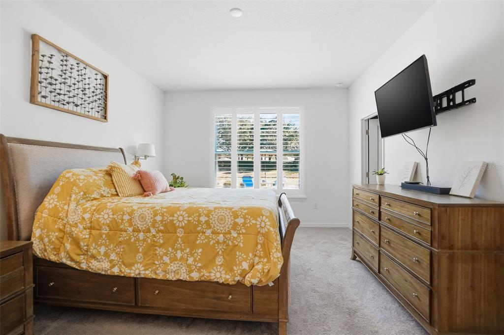 5365 Cappleman Loop Brooksville, FL 34601 - Photo 21 of 52 a bed sitting in a bedroom next to a window