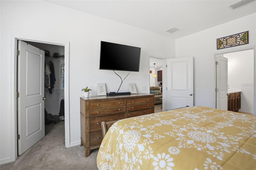 5365 Cappleman Loop Brooksville, FL 34601 - Photo 22 of 52 a bedroom with a bed and a flat screen tv