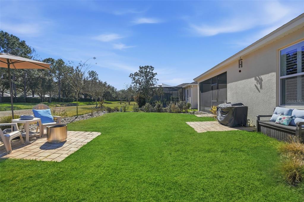 5365 Cappleman Loop Brooksville, FL 34601 - Photo 40 of 52 a view of a house with backyard sitting area and garden