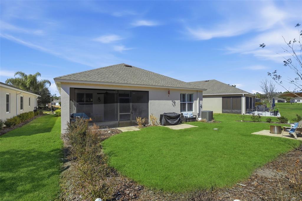 5365 Cappleman Loop Brooksville, FL 34601 - Photo 44 of 52 a front view of a house with a garden and porch