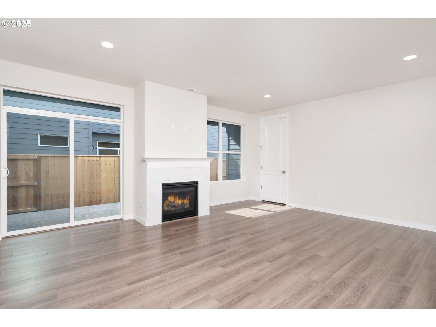 3147 South Kodiak Street, Unit LT798 Cornelius, OR 97113 - Photo 12 of 24 an empty room with wooden floor and fireplace