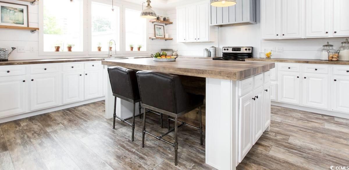 3702 Horse Pen Bay Road Aynor, SC 29511 - Photo 5 of 11 Kitchen with butcher block counters, a kitchen bar, open shelves, pendant lighting, and white cabinets