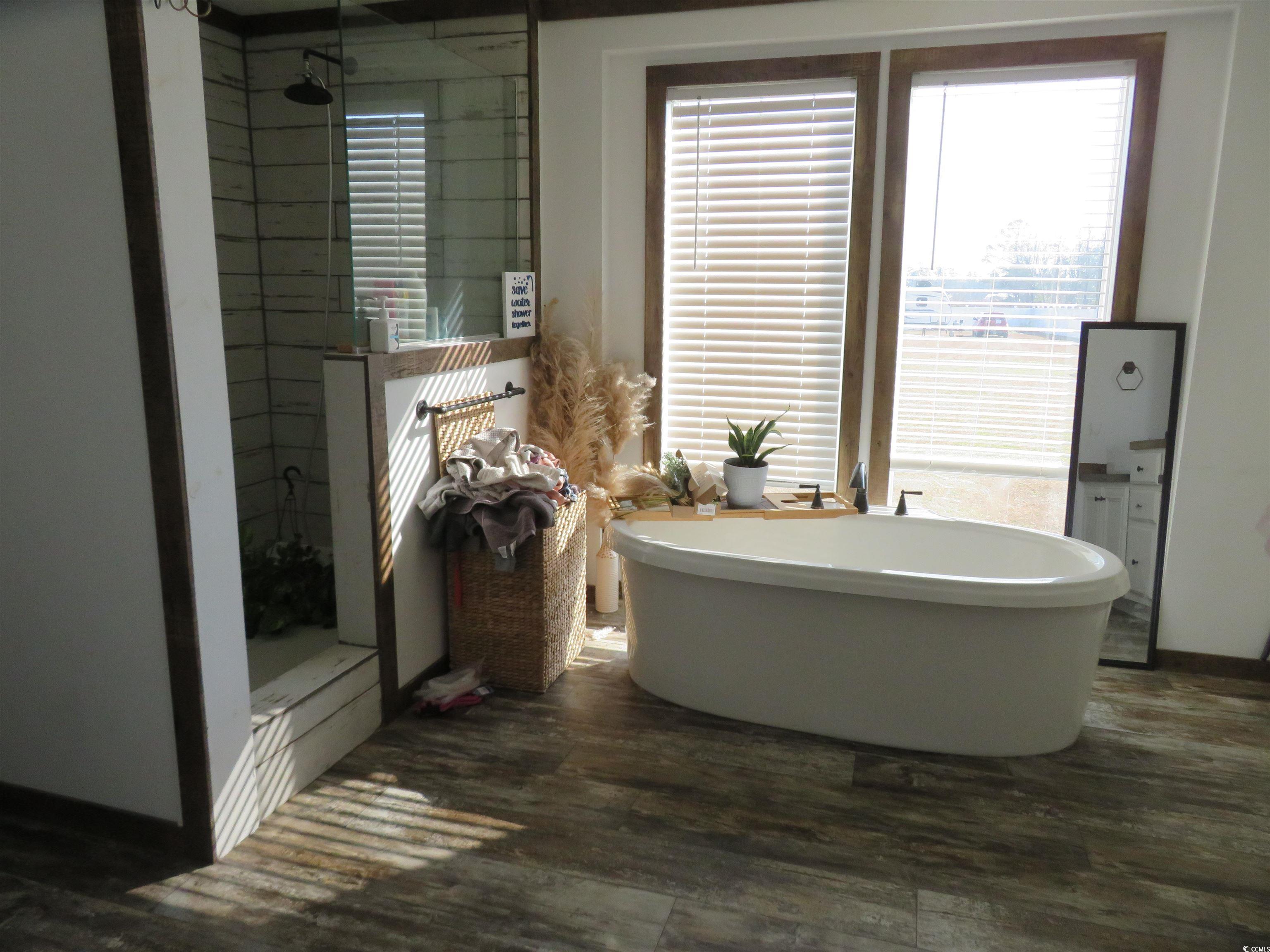 3702 Horse Pen Bay Road Aynor, SC 29511 - Photo 6 of 11 Bathroom featuring a stall shower, a freestanding bath, and dark wood-style floors
