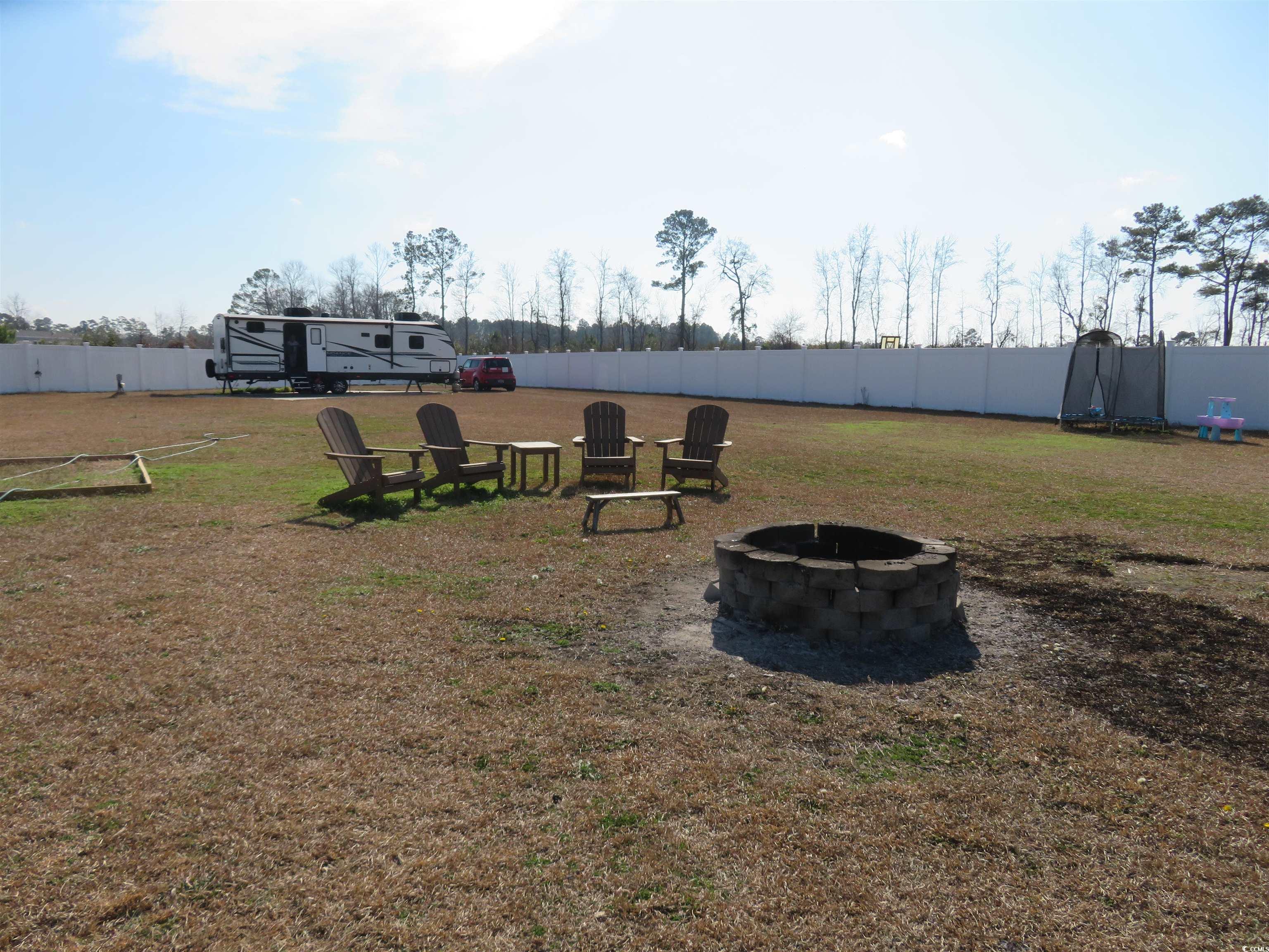 3702 Horse Pen Bay Road Aynor, SC 29511 - Photo 7 of 11 View of yard with a fire pit and a trampoline