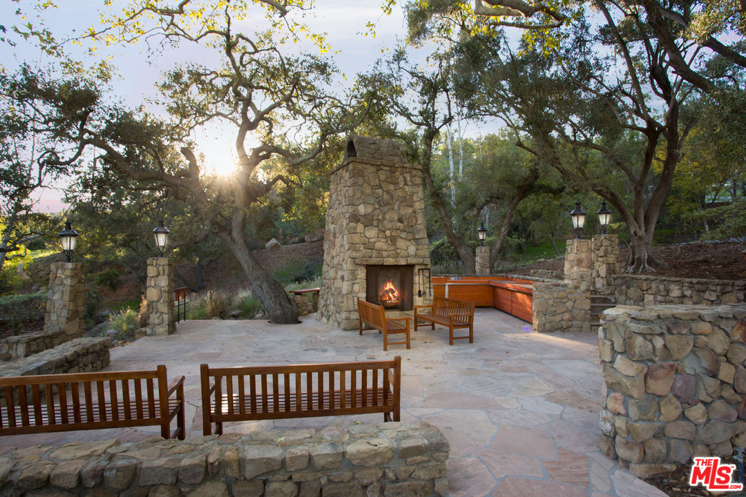 1753 Hidden Valley Road Thousand Oaks, CA 91361 - Photo 16 of 43 a view of a patio with couches and table and chairs with wooden fence and floor