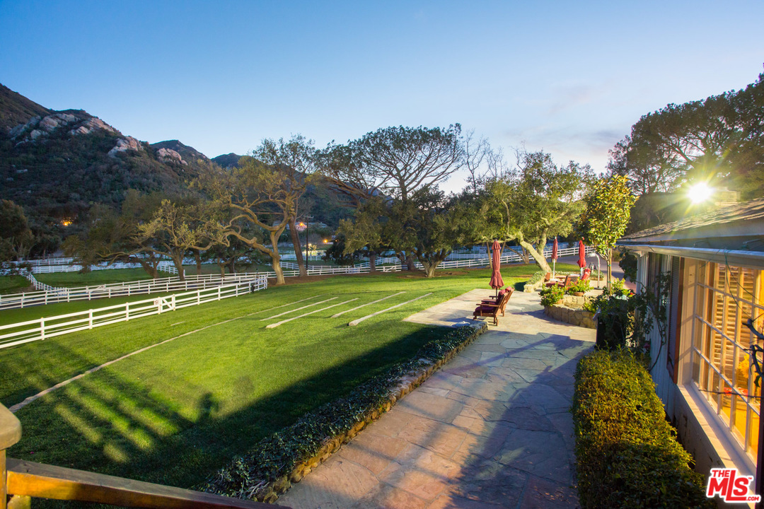1753 Hidden Valley Road Thousand Oaks, CA 91361 - Photo 7 of 43 a view of a swimming pool with a yard and a large tree