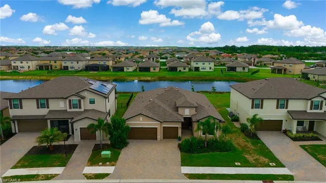 an aerial view of multiple houses with a yard