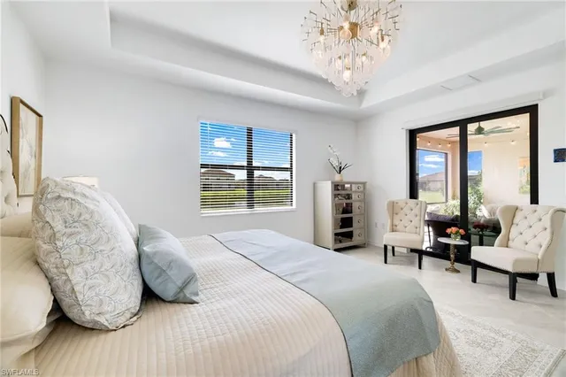 a bedroom with bed and large windows