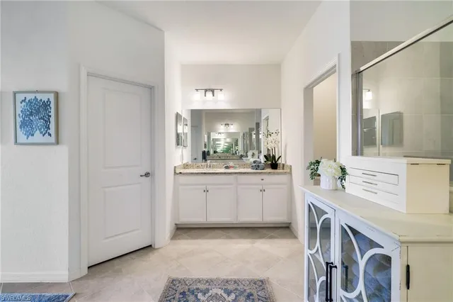 a bathroom with a double vanity sink and mirror